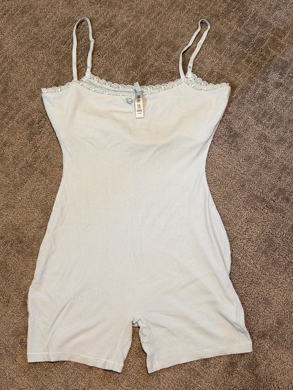Skims Fits Everybody white ribbed lace onesie.